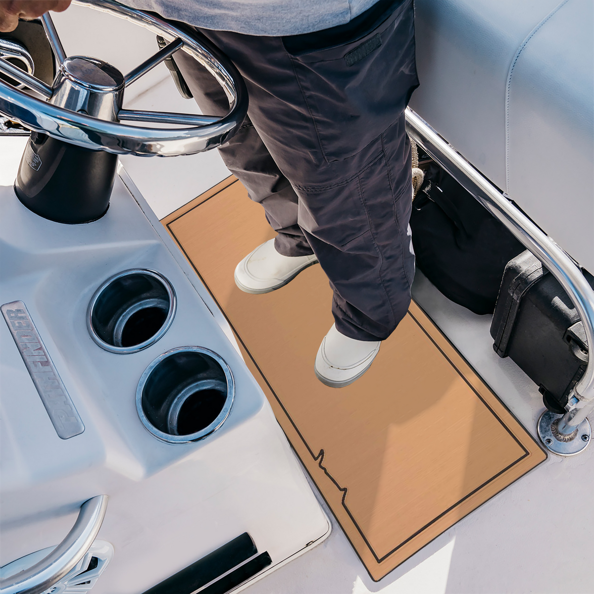 Teak-over-black EVA foam helm pad on a boat cockpit floor, designed to improve comfort, traction, and fatigue reduction for the captain.